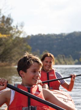 Mother and son enjoying a day of kayaking along Hawkesbury River, near Lower MacDonald