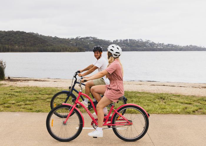Couple enjoying a day of cycling on the Narrabeen Lagoon Trail, Narrabeen