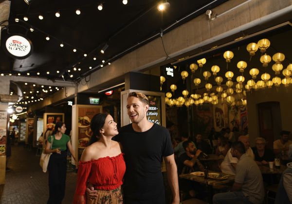 Couple enjoying food and drink in Spice Alley in Chippendale