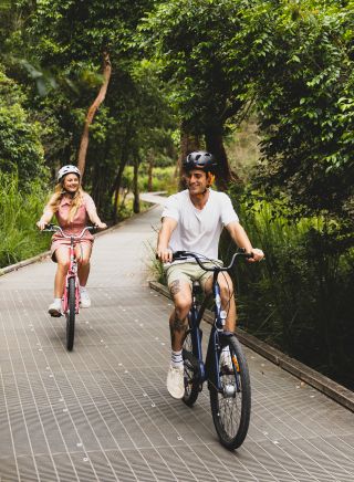Couple enjoying a day of cycling on the Narrabeen Lagoon Trail, Narrabeen