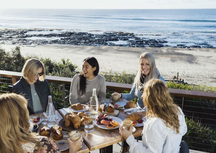 Friends enjoying food at Shelly Beach Cafe in Ballina, Byron Bay in North Coast