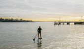 Man enjoying a morning of stand up paddleboarding in Port Hacking near Bundeena Wharf, Bundeena