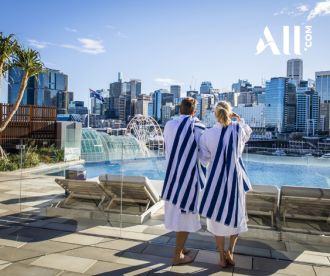 Couple overlooking the pool at Sofitel Hotel, Darling Harbour