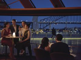 Couple enjoying an evening out with friends at Bennelong Restaurant in Sydney Opera House Bennelong Restaurant, Sydney