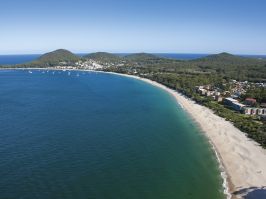 Coastal aerial of Shoal Bay beach in Port Stephens with views towards Mount Tomaree Shoal Bay, Port Stephens