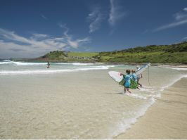 Children heading out for a surf at Killalea State Park, "The Farm" Killalea State Park, Shell Cove