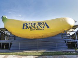 Sun shining over the sign welcoming visitors to The Big Banana attraction in Coffs Harbour Big Banana, Coffs Harbour