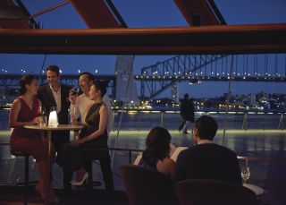 Couple enjoying an evening out with friends at Bennelong Restaurant in Sydney Opera House Bennelong Restaurant, Sydney