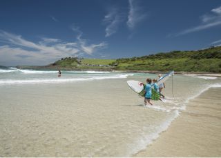 Children heading out for a surf at Killalea State Park, "The Farm" Killalea State Park, Shell Cove