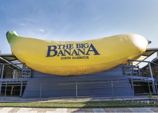 Sun shining over the sign welcoming visitors to The Big Banana attraction in Coffs Harbour Big Banana, Coffs Harbour