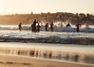 Swimmers heading out into the ocean from Bondi Beach, Sydney East