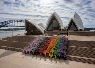 Sydneysiders created a giant human Progress Flag on the steps of the Sydney Opera House to celebrate WorldPride 2022, Sydney