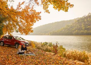 Couple enjoying a romantic picnic by Hawkesbury River, Wisemans Ferry