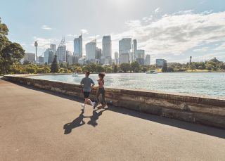 Couple running through the Royal Botanic Gardens, Sydney