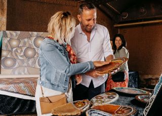 Couple browsing through Aboriginal artwork for sale, Blak Markets, Bare Island, La Perouse