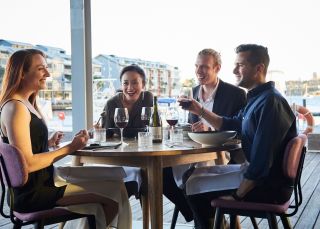 Friends enjoying food and drink waterside, LuMi Bar & Dining, Pyrmont 
