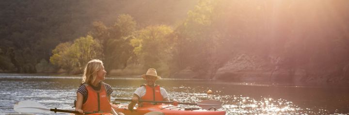 Couple kayaking in afternoon sun, Hawkesbury River