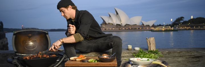 Hayden Quinn cooking with Opera House in background, Sydney Harbour