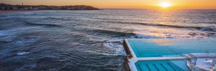 Morning sun rising over Bondi Icebergs, Bondi Beach