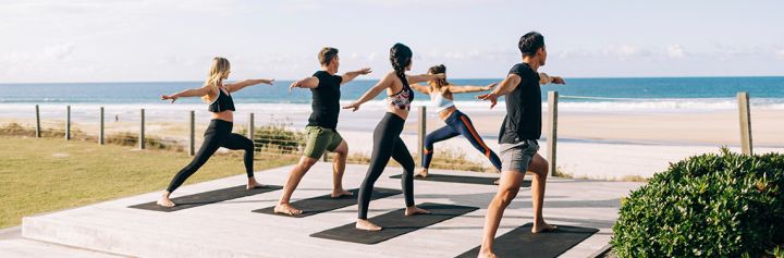 Elements of Byron guests enjoying morning beachfront yoga sessions, Byron Bay