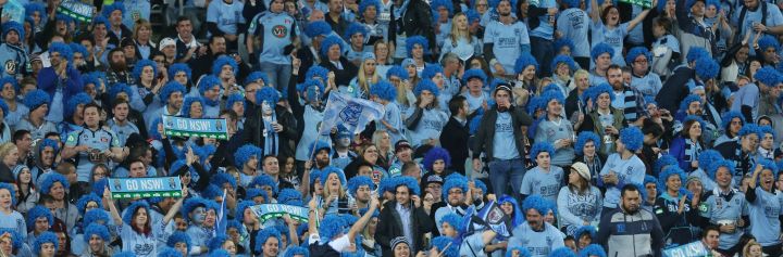 Crowd of NSW blues fans cheering in the stadium