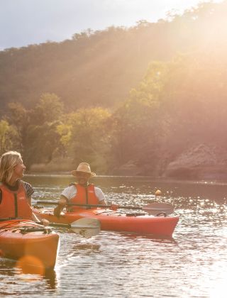 Couple kayaking in afternoon sun, Hawkesbury River