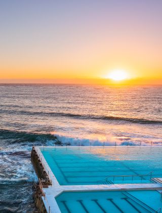 Morning sun rising over Bondi Icebergs, Bondi Beach