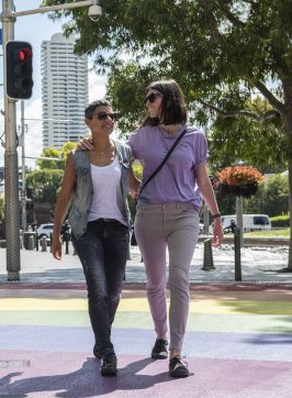 Couples crossing the rainbow path near Taylor Square, Darlinghurst.