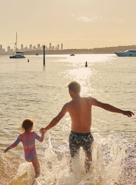 A father and child enjoying the water at Camp Cove, Watsons Bay