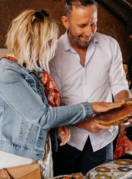 Couple browsing through Aboriginal artwork for sale, Blak Markets, Bare Island, La Perouse