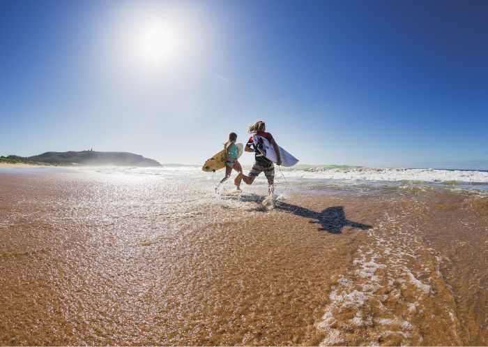 Two surfers heading out to enjoy the morning waves at Sydney's Palm Beach