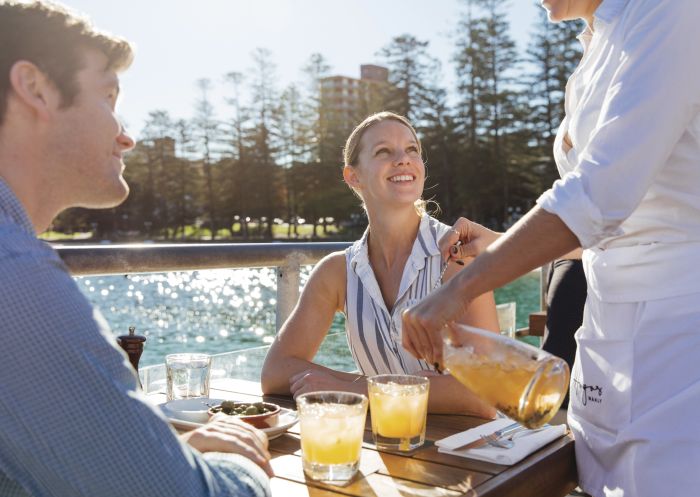 Couple enjoying food and drinks at Hugos Manly at Manly Wharf