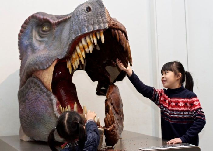 Girls running their hands over the teeth of a Tyrannosaurus Rex skull, Australian Museum