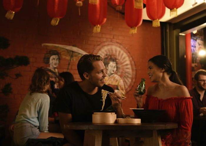 Couple enjoying food and drink in Spice Alley, Chippendale