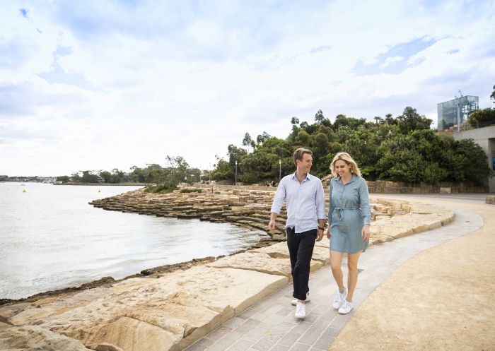 Couple enjoying a walk around Nawi Cove in Barangaroo, Sydney City