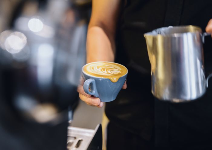 Barista making morning coffees at Artificer Cafe in Surry Hills, Inner Sydney