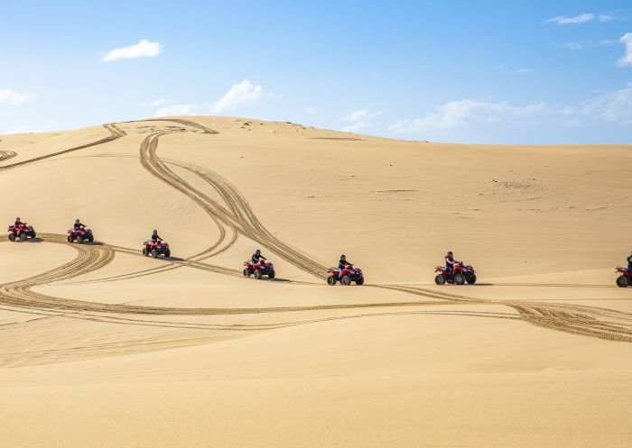 Small group enjoying an Aboriginal cultural tour on quad bikes with Sand Dune Adventures, Port Stephens