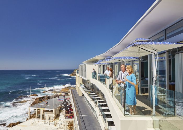 A couple enjoying the views from Icebergs Dining Rooms and Bar, Bondi