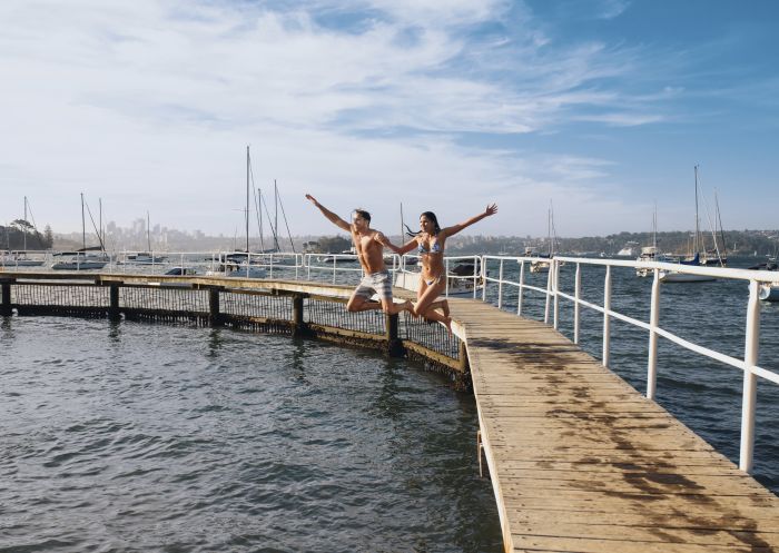 Couple relaxing by Murray Rose Pool in Double Bay, Sydney