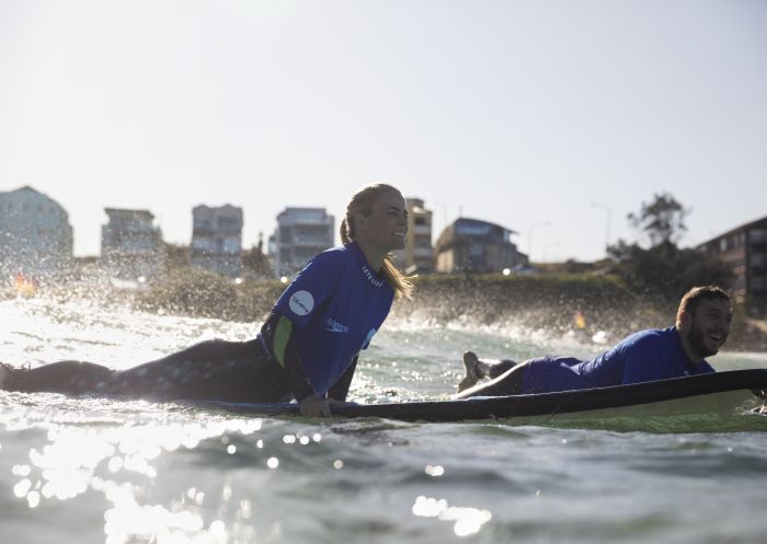 Couple enjoying a surf lesson with Lets Go Surfing, Bondi Beach