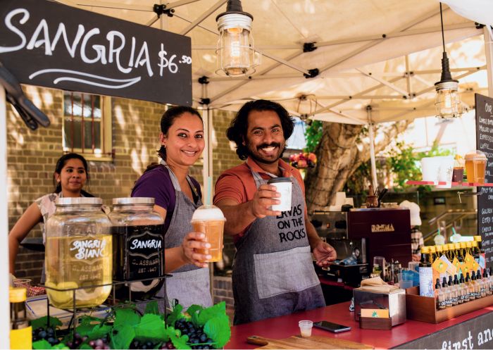 Stall owners with beverages at The Rocks Friday Foodie Market