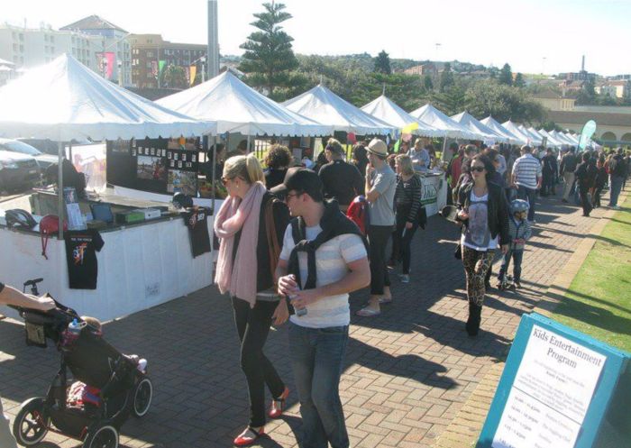 Long row of stalls with shoppers walking along footpath at Bondi Markets, Bondi - Credit: Bondi Markets