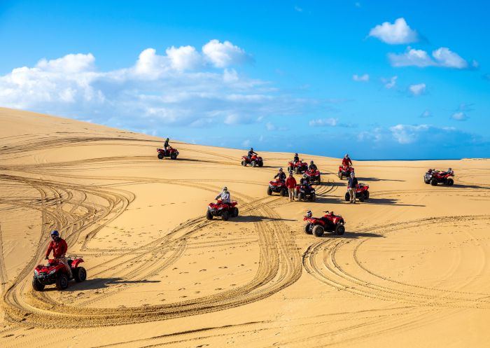 Small group enjoying an Aboriginal cultural tour on quad bikes with Sand Dune Adventures, Port Stephens