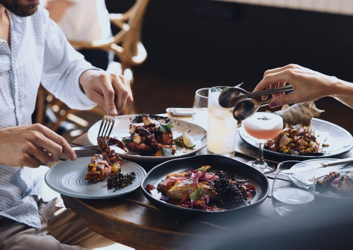 Couple enjoying food and drink at The Butler, an open patio bar located on Victoria Street, Potts Point