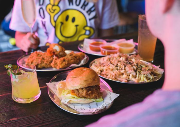 Couple enjoying friend chicken and drinks at Butter in Surry Hills