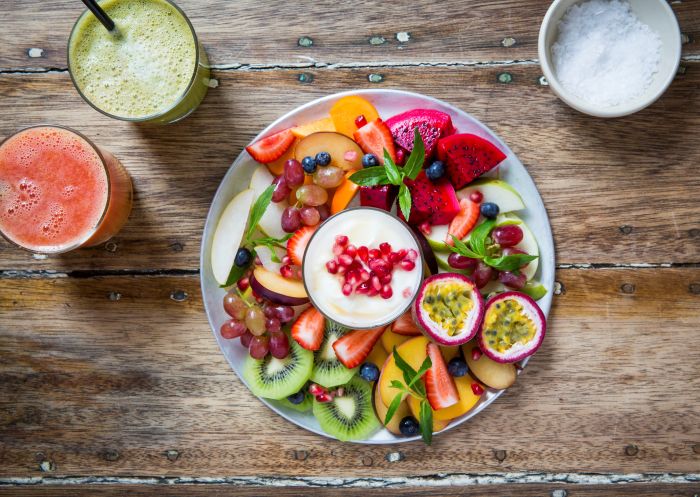 The Fruit Plate (seasonal fresh fruit with biodynamic yoghurt) and fresh juices available at Bread & Circus Wholefoods Canteen, Alexandria