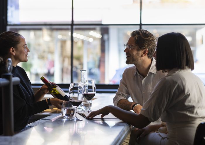 Couple enjoying a bottle of red wine at Coogee Wine Room in Coogee, Sydney East