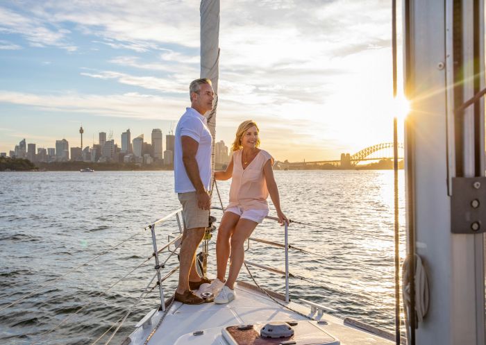 Couple enjoying harbour views from a chartered sailing vessel on Sydney Harbour