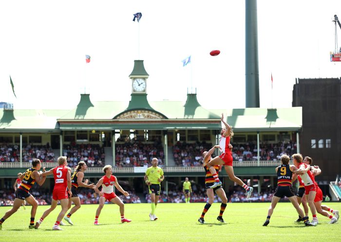 A player jumping up to get the ball at Swans game, Sydney
