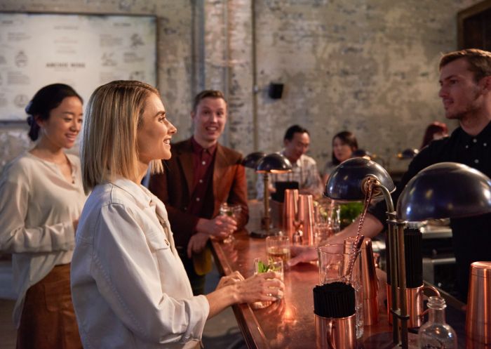 Woman ordering a drink at Archie Rose Distillery Co. bar, Rosebery